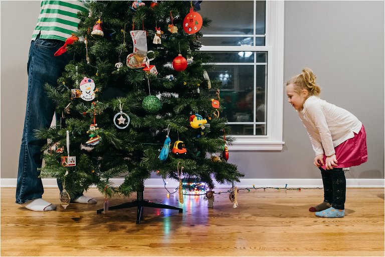 family decorates Christmas tree - Lifestyle Family Photography