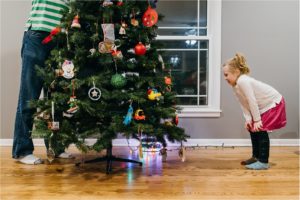 family decorates Christmas tree - Lifestyle Family Photography