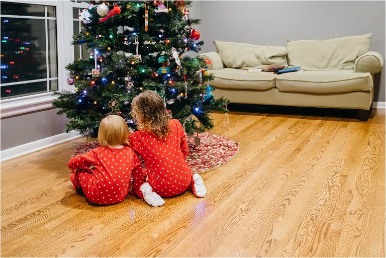girls in matching pajamas at Christmas tree - Lifestyle Family Photography