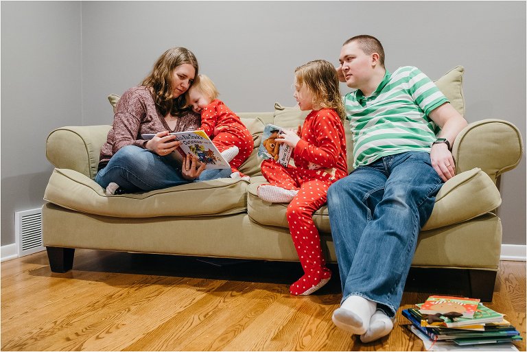 family reads book together on couch - Lifestyle Family Photography