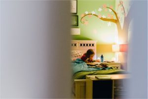 girl reads alone in bed - Lifestyle Family Photography