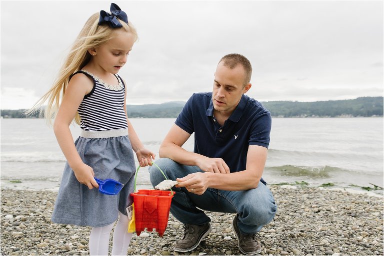 father slips shell into daughter's bucket