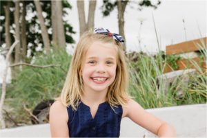 girl sits for beach portrait