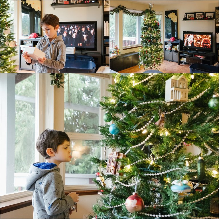 5 year old boy helps decorate Christmas tree
