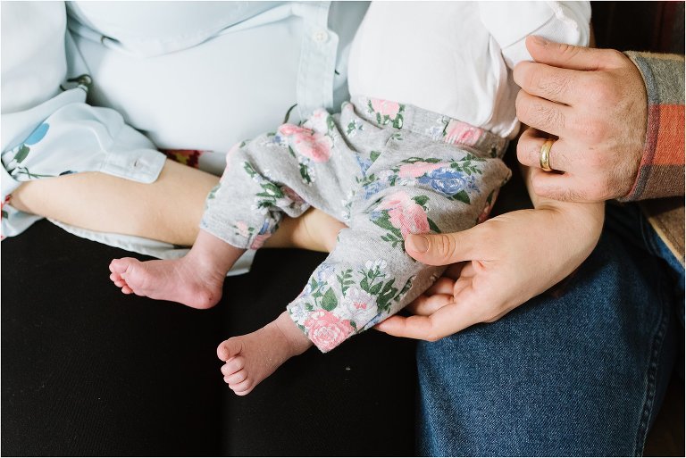 baby feet in parents' laps - Poulsbo Lifestyle Newborn Photographer