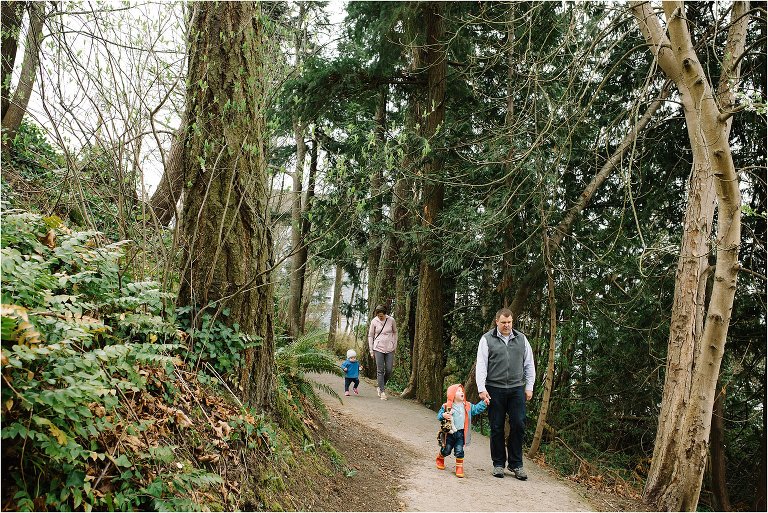 family hiking through tall trees - Kitsap Lifestyle Family Photographer