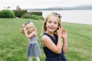 Documentary photo of girls in blue making mirrored gesture.