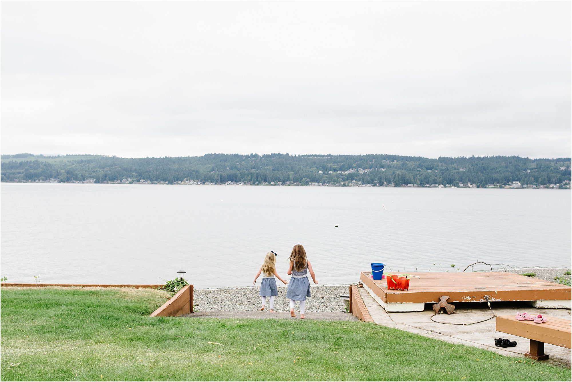 lifestyle image of twin girls approaching rocky shoreline in Bremerton Washington.
