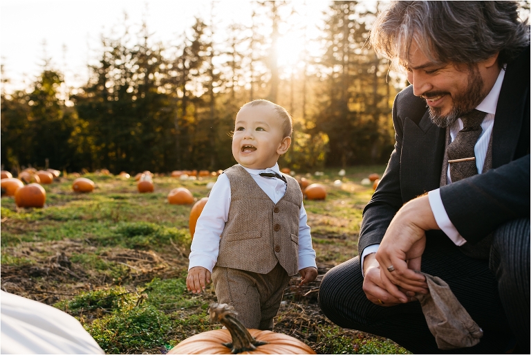 boy in suit with father in pumpkin patch 